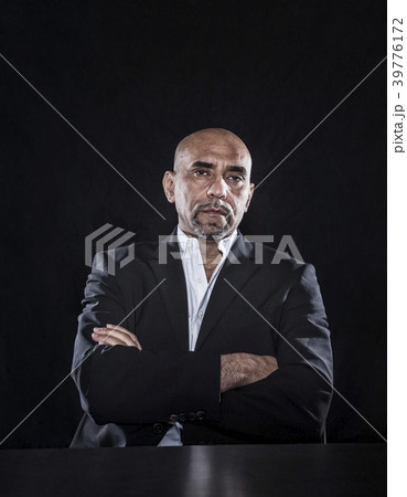 Studio portraits of Hispanic man holding props. 39776172