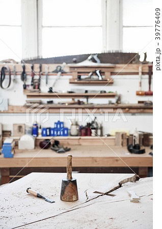 A work station with tools in a woodworking factory. 39776409