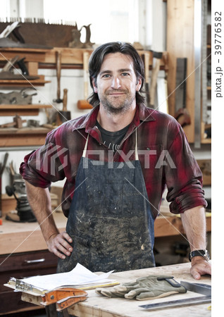 Caucasian man factory worker at a work station in a woodworking factory. 39776582