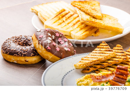 Scrembled eggs with panini toast and donut Scrembled eggs with panini toast and donut 39776709