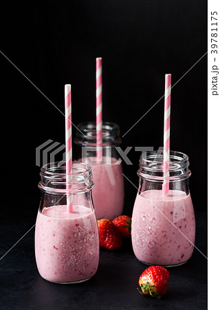 Fresh strawberry smoothies on black background 39781175