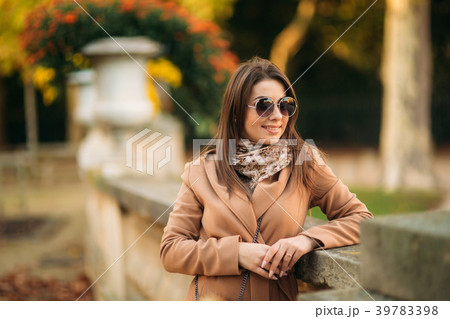 Stylish girl in a brown coat and a scarf with Stylish girl in a brown coat and a scarf with 39783398