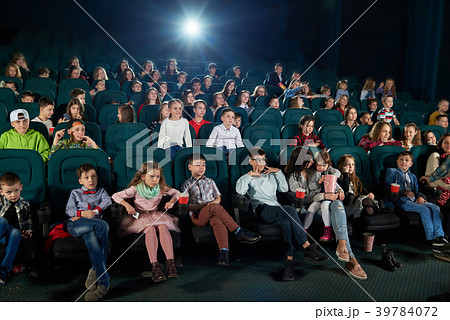 Frontview of people watching movie in the cinema Frontview of people watching movie in the cinema 39784072