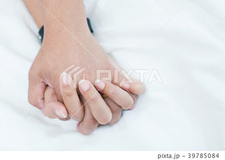 Hands stranglehold of couple lovers on a bed  39785084