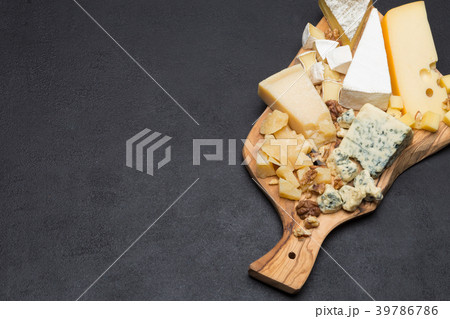 various types of cheese on wooden board 39786786