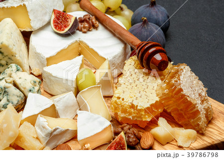 Camembert cheese with honey, figs, walnuts on 39786798