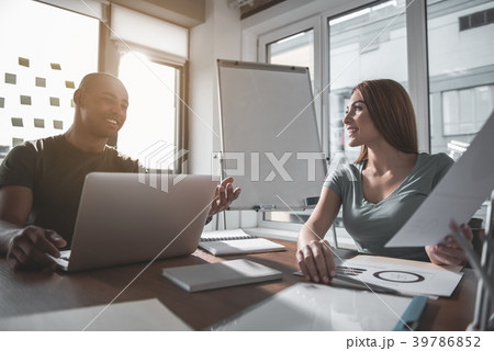 Glad man and woman discussing project in Glad man and woman discussing project in 39786852