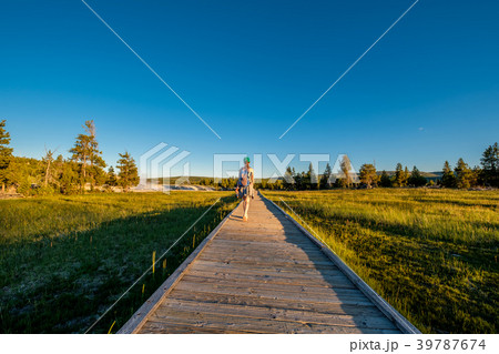 Tourist with backpack hiking in Yellowstone Tourist with backpack hiking in Yellowstone 39787674