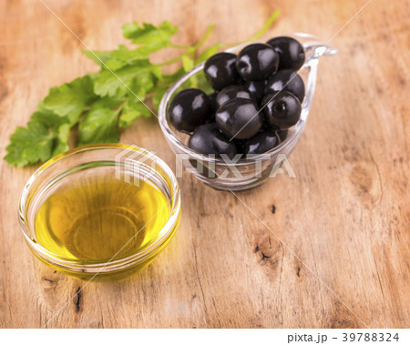 Olives and Healthy Olive oil  cup with parsley Olives and Healthy Olive oil  cup with parsley 39788324
