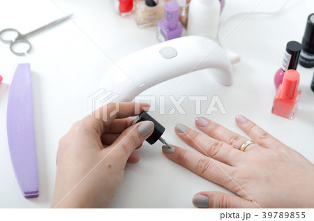 Woman using UV light dryer 39789855