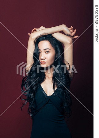 Beautiful asian woman in black dress posing in studio 39790538