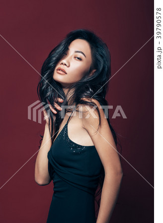 Beautiful asian woman in black dress posing in studio 39790578