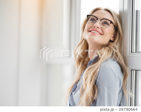 Excited blond businesswoman enjoying peace near 39790664