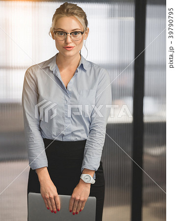 Successful business lady holding notebook computer Successful business lady holding notebook computer 39790795