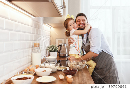 happy family in kitchen. Father and child daughter knead dough a happy family in kitchen. Father and child daughter knead dough a 39790841