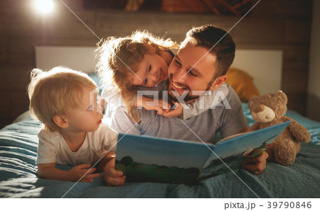evening family reading. father reads children . book before goin 39790846