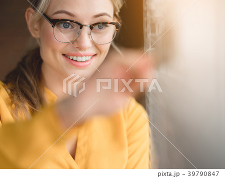 Positive woman fixing window louvers 39790847