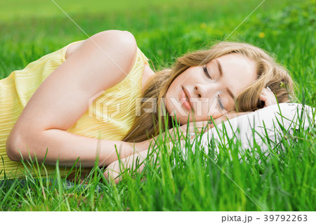 Woman sleeping on grass 39792263
