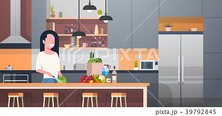 Woman Cooking Salad In Modern Kitchen Room 39792845