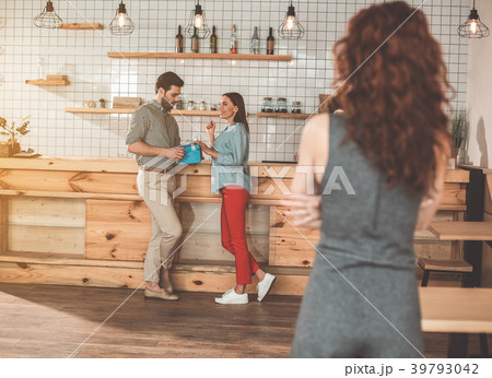 Jealous lady looking at her boyfriend cheating 39793042