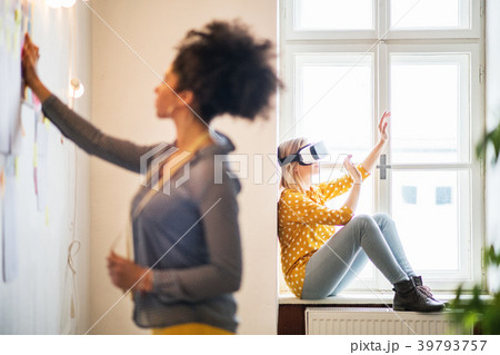 Young creative women with VR goggles in studio 39793757