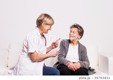 Studio portrait of a senior nurse examining an Studio portrait of a senior nurse examining an 39793831