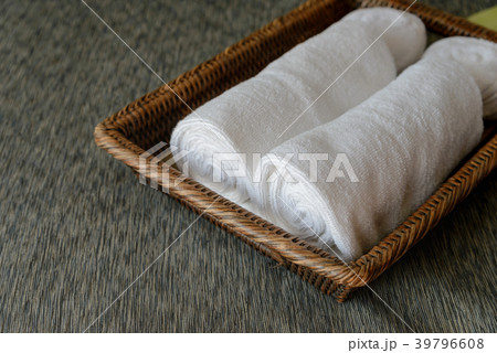White rolled towels in wicker basket White rolled towels in wicker basket 39796608