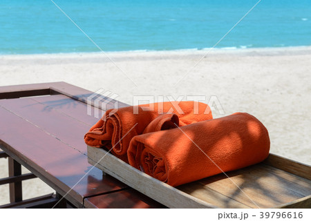 orange towels in wooden box near beach 39796616
