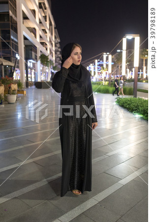 Muslim woman wearing in a hijab walks in the night Muslim woman wearing in a hijab walks in the night 39798189