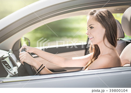 woman sitting in the interior of a new car with woman sitting in the interior of a new car with 39800104