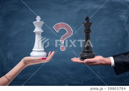 A chalk question mark between a female hand with a A chalk question mark between a female hand with a 39803764