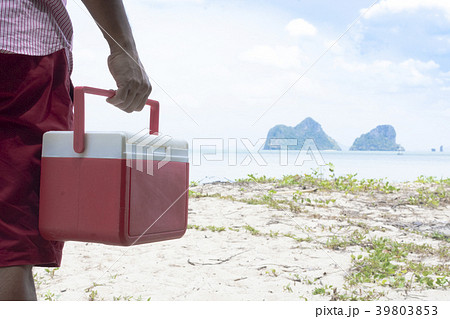 Hand of man red Ice box with background the beach  39803853