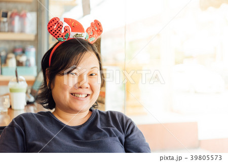 Asian woman and santa claus headband laugh smile 39805573