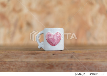 Cup heart shape on wooden floor in Valentine's Day 39805909