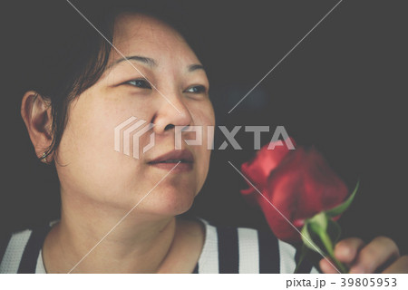 Woman smelling Red rose flower in Valentine's Day Woman smelling Red rose flower in Valentine's Day 39805953