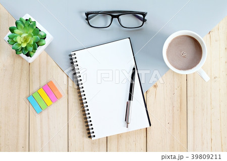 Notebook and coffee cup on office table 39809211