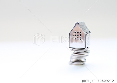 House model standing on coins stack 39809212
