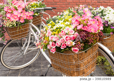 Beautiful colorful flowers in a basket of bicycle. Beautiful colorful flowers in a basket of bicycle. 39810989