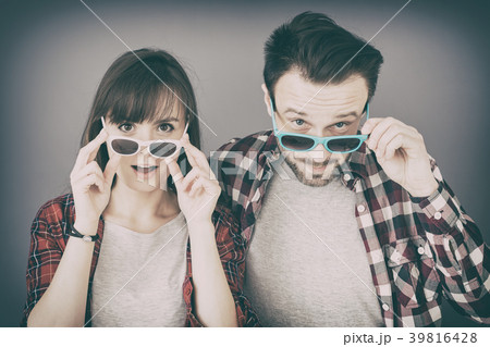 A pair people glasses and opens her mouth in surp 39816428