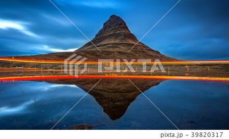 Kirkjufell mountains and reflection with car light Kirkjufell mountains and reflection with car light 39820317