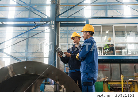 Experts checking information on tablet PC in a 39821151