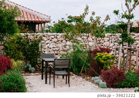 Chairs and table in spring garden with tree shrubs 39821222