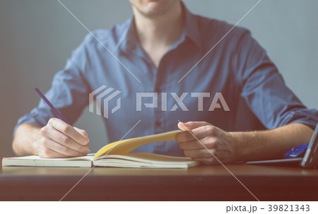 Businessman writing a document on notebook 39821343
