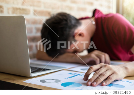 Tired businessman sleeping at work in modern office with hand ho 39821490