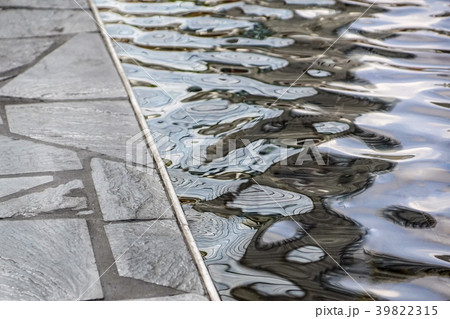 A drop of water on a stone that is varnished. A drop of water on a stone that is varnished. 39822315