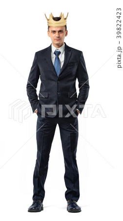 An isolated businessman stands with a golden crown 39822423