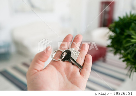 Mortgage concept. Men hand holding key with house 39826351