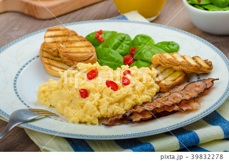 Scrambled eggs with toast and fresh salad Scrambled eggs with toast and fresh salad 39832278