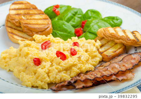 Scrambled eggs with toast and fresh salad Scrambled eggs with toast and fresh salad 39832295