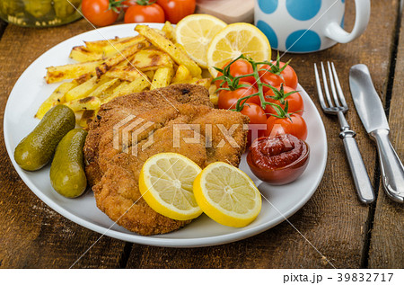 Big Chicken schnitzel with homemade chilli french fries Big Chicken schnitzel with homemade chilli french fries 39832717